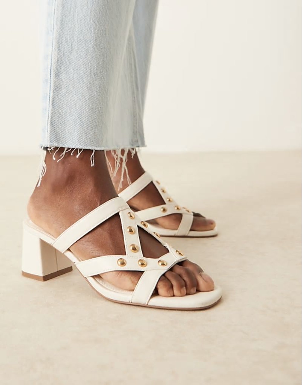 Howdy stud detail caged mid heeled mules in off white