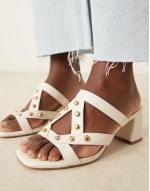Howdy stud detail caged mid heeled mules in off white