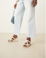 Howdy stud detail caged mid heeled mules in off white